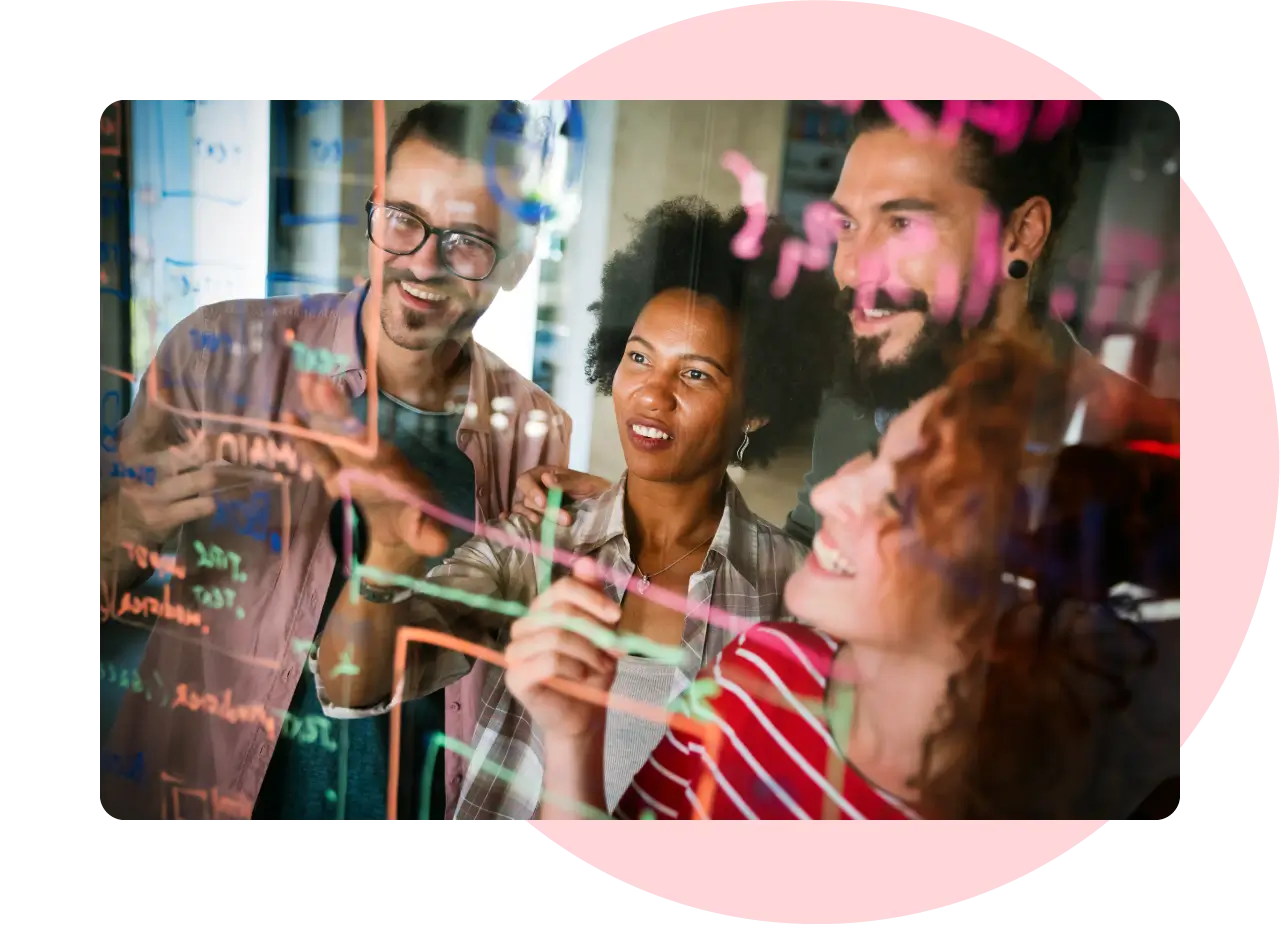 Group of young professionals in front of a glass screen with metrics and data on it.