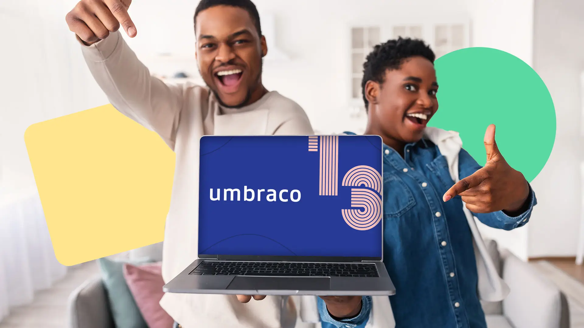 Man and woman pointing at laptop, showing Umbraco 13 on the display.